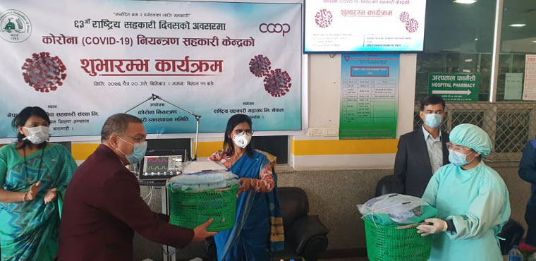 Minister Padma Aryal handing over necessary goods to the medical staff needs during COVID-19 related works at the center.