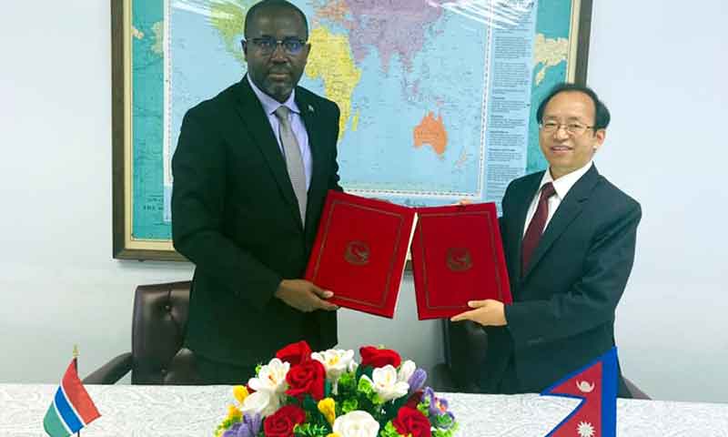 Ambassador of Nepal and the Ambassador of Gambia to the United Nations Amrit Bahadur Rai (right) and Lang Yabu exchanging the signed document after establishing the diplomatic relationships between the two countries amid a program organized in New York on Monday.