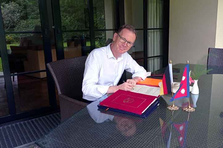 German Ambassador to Nepal Roland Schäfer signing a grant assistance document that Germany pledges to support of EUR 34.4 million to Nepal at embassy on Monday. Photo Embassy of Germany/Facebook