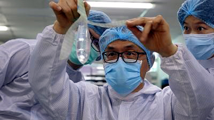 Founder and inventor of Wondaleaf Unisex Condom John Tang Ing Ching inspects the unisex condom at his factory in Sibu, Malaysia. Photo: Twin Catalyst via Reuters Photo