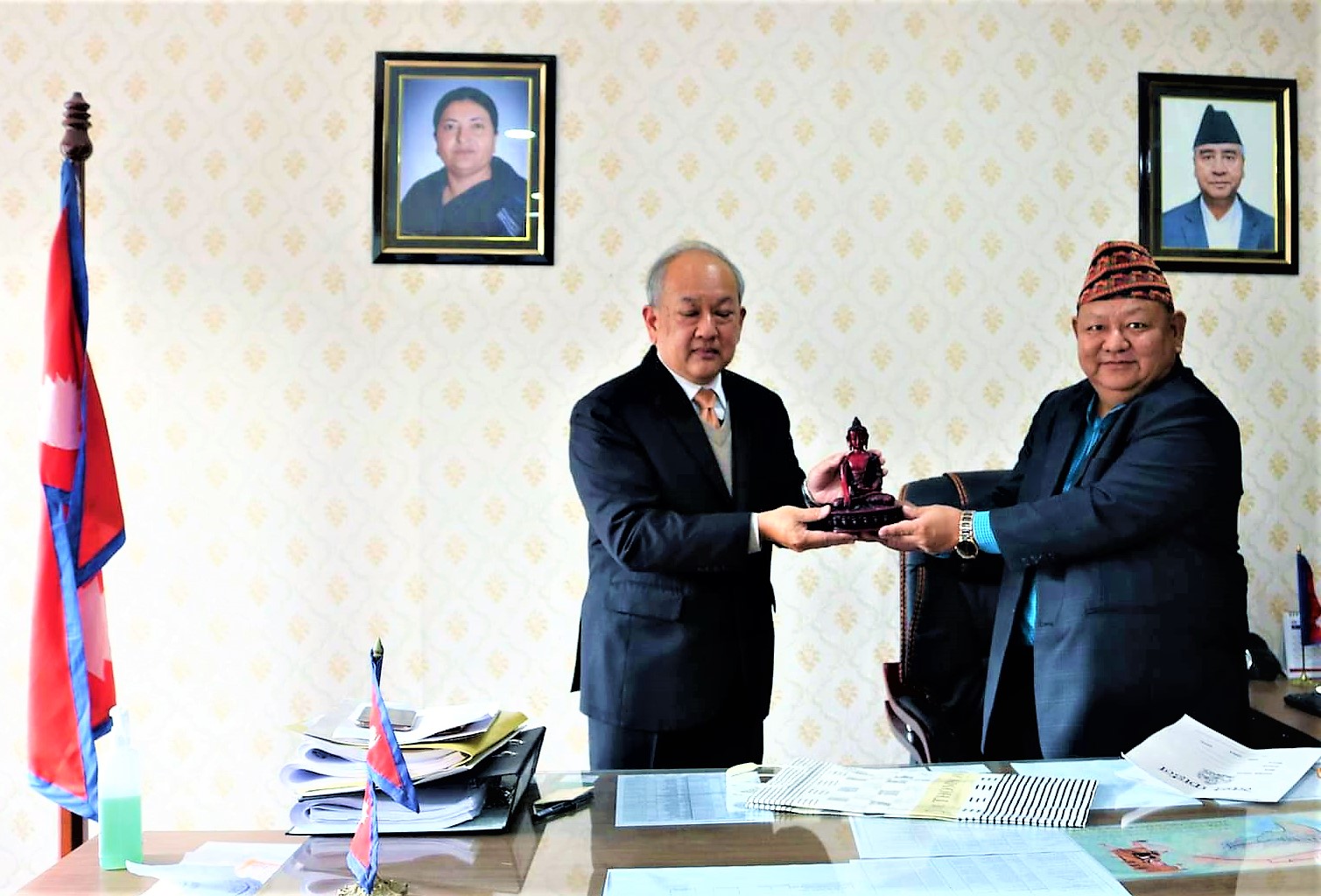 Minister Ale and Thai envoy exchanging gift at the Minister’s chamber Thursday. Ministry photo