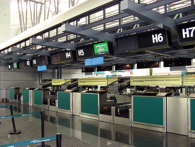 Empty passenger service counter at airport. Wikimedia Commons