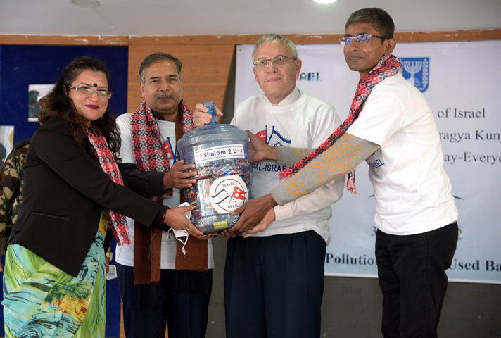 Minister for Forests and Environment Ramsahay Prasad Yadav (second from left) and the Ambassador of Israel to Nepal Hanan Godar (second from right) handing over a jar of used batteries to the representative of the Doko Recyclers at a function held in the capital on Monday January 3.