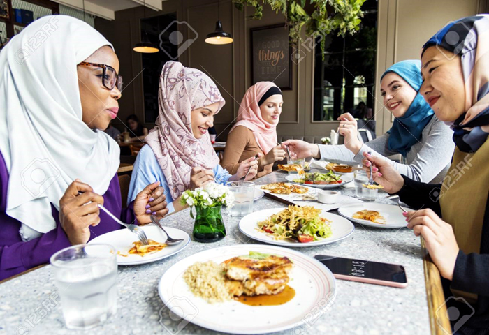 Muslim women eating food. Image credit Stock Photo