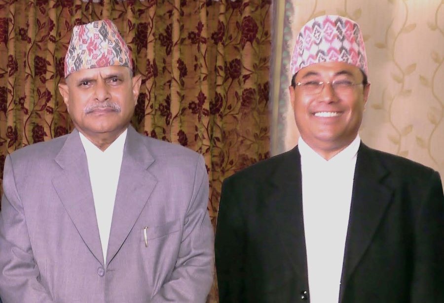 File Photo: The Writer wearing Nepali Topi along with Daura Suruwal with the then first President of the Federal Democratic  Republic of Nepal Dr. Ram Baran Yadav.  
