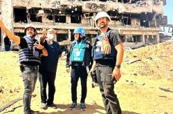 FILE PHOTO: UN staff with hospital director beside the ruins of the Al-Shifa Hospital in Gaza, April 2024. Image credit WHO