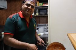 Pahal prepares his signature Chicken Tikka Masala at his family’s Himalayan Gorkha Indian & Nepalese Restaurant in Pristina, bringing the flavours of Nepal to Kosovo. Photo: IOM/Dijar Mehmeti