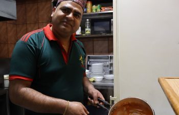 Pahal prepares his signature Chicken Tikka Masala at his family’s Himalayan Gorkha Indian & Nepalese Restaurant in Pristina, bringing the flavours of Nepal to Kosovo. Photo: IOM/Dijar Mehmeti